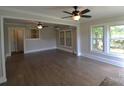 Bright living room featuring hardwood floors, neutral walls, and multiple ceiling fans at 303 Nc Hwy 200 N Hwy, Stanfield, NC 28163