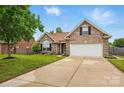 Brick home featuring a well-manicured lawn, a two-car garage, and a classic design at 3327 Flagler Cir, Midland, NC 28107