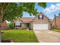 Well-maintained brick home with mature trees, a two-car garage, and a landscaped front yard at 3327 Flagler Cir, Midland, NC 28107