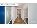 Inviting entryway featuring hardwood floors, a decorative glass door, and French doors at 3412 Lacebark Ln, Gastonia, NC 28056