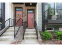 Close-up of two townhome entryways, each featuring a painted front door, stairs and decorative accents at 355 S Bruns Ave, Charlotte, NC 28208