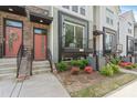 Modern townhome exterior showcasing brick accents, dark trim, small porch, and tidy landscaping at 355 S Bruns Ave, Charlotte, NC 28208