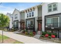 Charming townhome exterior with a modern design, featuring a small porch, brick accents, and landscaped front yard at 355 S Bruns Ave, Charlotte, NC 28208