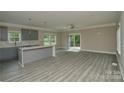 Open concept living room with gray floors and sliding glass doors to the exterior at 4006 Scarlet Dr # 29, Matthews, NC 28104
