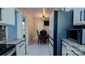 Bright kitchen showcasing granite countertops, white cabinets, and stainless steel refrigerator at 403 3Rd Nw St, Conover, NC 28613