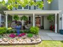 Cozy front porch with hanging ferns, wicker chairs, and a beautiful rock garden at 4148 Shasta Cir, Clover, SC 29710