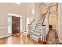 Grand foyer with hardwood floors, a staircase, and ample natural light at 4232 Shannamara Dr, Matthews, NC 28104