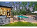 Outdoor oasis featuring a pool, patio, fire pit, and covered porch with grill at 425 W North Corner Rd, Lancaster, SC 29720