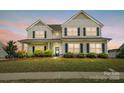 Charming two-story home features a covered porch, well-maintained lawn and manicured shrubs at 4321 Hornyak Dr, Monroe, NC 28110