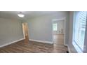 Open-concept living room with vinyl floors, neutral walls, and ample natural light at 440 27Th Street Sw Pl, Hickory, NC 28602