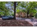 View of townhomes surrounded by mature trees and ample parking spaces at 510 N Alexander St, Charlotte, NC 28202