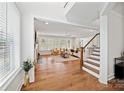 Bright and airy living room featuring hardwood floors and a staircase at 528 Rock Skip Way, Fort Mill, SC 29708