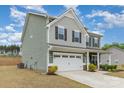 Green two-story home with an attached two-car garage and manicured front lawn at 6070 Trinity Crossing Cir, Kannapolis, NC 28081