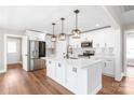 Bright, modern kitchen with white cabinets, stainless steel appliances, and a large center island at 640 Central Nw Dr, Concord, NC 28027