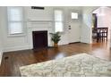 Bright living room with hardwood floors, decorative fireplace, and an arched entrance to the dining area at 645 Wilshire Sw Ave, Concord, NC 28027