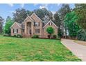 Beautiful brick home featuring a well-manicured lawn and a charming side-entry driveway at 7887 Mountain Shore Dr, Sherrills Ford, NC 28673