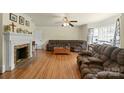 Spacious living room featuring a brick fireplace, hardwood floors, and comfortable furnishings at 828 N 6Th St, Albemarle, NC 28001