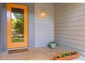 Close-up of the front door, displaying its bright orange color and stylish design at 901 Southland Rd, Huntersville, NC 28078