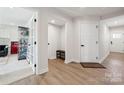 Welcoming entryway with hardwood floors and white doors showcases the home's modern style at 9823 Oaklawn Nw Blvd, Huntersville, NC 28078