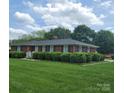 Quaint brick home with well-maintained lawn, complemented by neatly trimmed shrubbery and inviting entrance at 1165 Mt Moriah Church Rd, China Grove, NC 28023