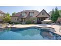 Resort-style backyard with a sparkling pool and expansive patio for outdoor entertaining at 1304 Lookout Cir, Waxhaw, NC 28173
