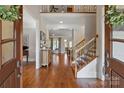 Grand foyer with gleaming hardwood floors, elegant staircase, and abundant natural light at 1304 Lookout Cir, Waxhaw, NC 28173