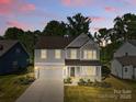 Beautiful two-story home featuring a manicured lawn and a two-car garage at 1308 Stone Marker Dr, Monroe, NC 28112