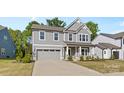 Charming two-story home with a manicured lawn and attached two car garage at 1308 Stone Marker Dr, Monroe, NC 28112