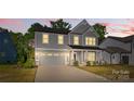 Charming two-story home with a manicured lawn and an attached two-car garage at 1308 Stone Marker Dr, Monroe, NC 28112