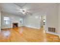 Bright living room with hardwood floors, fireplace, and abundant natural light at 146 Walnut St, Chester, SC 29706