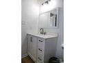 Modern bathroom featuring a white vanity with black fixtures, a stylish mirror, and tiled flooring at 149 Glenwood Dr, Rock Hill, SC 29732
