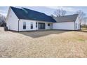 Spacious backyard featuring a modern white home with large windows and a sliding door at 1706 Ruben Rd, Monroe, NC 28112