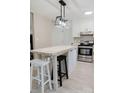 Well-lit kitchen with an island, modern appliances, and sleek countertops at 18 Shannon Ct, Newton, NC 28658