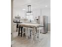 Bright kitchen with white cabinetry, stainless steel appliances, and a central island with seating at 18 Shannon Ct, Newton, NC 28658