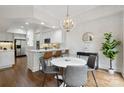 Bright dining area featuring a modern chandelier and stylish wallpaper next to the kitchen at 1806 Asbury Hall Ct, Charlotte, NC 28209
