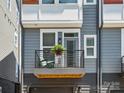 Charming outdoor balcony space offers a cozy spot to relax with a chair and a potted plant at 2111 Isom St, Charlotte, NC 28208