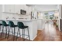 Modern kitchen with stainless steel appliances, quartz counters, and stylish green barstools at 2111 Isom St, Charlotte, NC 28208