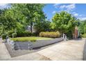 Well-maintained front yard with a retaining wall, lush lawn and landscaping of this charming home at 2125 Chatham Ave, Charlotte, NC 28205