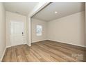 Inviting living room featuring wood-look floors, and a bright window at 2127 Rolling Hills Ct, Stanley, NC 28164