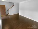 Open-concept living room with hardwood floors, offering a versatile space for relaxation and entertainment at 2140 Majestic Poplar Dr, Waxhaw, NC 28173