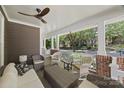 Cozy back porch with wicker furniture, ceiling fan, and a pleasant view of the neighborhood at 2311 Club Rd, Charlotte, NC 28205