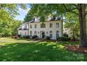 Attractive two-story home surrounded by lush greenery and featuring a well-maintained lawn at 2556 Howerton Ct, Charlotte, NC 28270