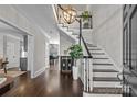 Stunning foyer with a grand staircase, hardwood floors, and stylish lighting fixtures at 2556 Howerton Ct, Charlotte, NC 28270