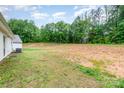 Spacious, cleared backyard with green grass and potential for landscaping or recreation at 3138 Maple Ridge Dr, Gaston, NC 28052