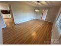 Bright dining room with wood floors and a modern chandelier at 396 Pitts School Nw Rd, Concord, NC 28027
