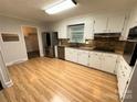 Kitchen featuring stainless steel appliances, stone backsplash and wood floors at 396 Pitts School Nw Rd, Concord, NC 28027