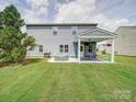 Spacious backyard with a covered patio and hot tub, perfect for outdoor entertaining and relaxation at 4008 Houndscroft Rd, Indian Trail, NC 28079