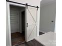 Whitewashed wooden sliding barn door with black hardware, showcasing access to another room at 418 W Westview St, Gastonia, NC 28052
