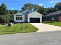 Beautiful exterior of a craftsman-style home with a well-manicured lawn, concrete driveway, and two car garage at 418 W Westview St, Gastonia, NC 28052