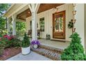 Inviting front porch of home with rocking chairs and decorative plants, perfect for relaxing at 4290 Palm Dr, Denver, NC 28037